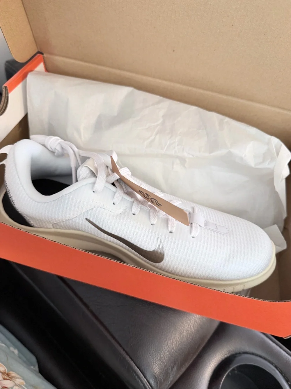Nike Women's White Sneakers with Silver Swoosh and Black Heel Accent
